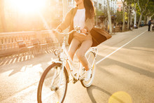 Cropped Photo Of Young Lady On Bicycle On The Street.