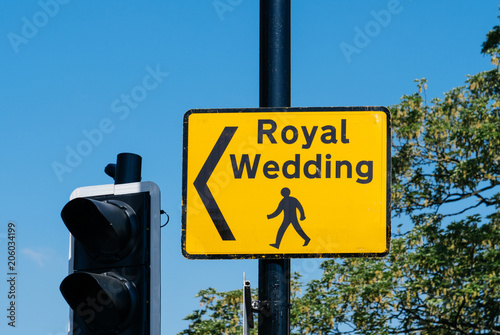 Fotografie, Tablou Royal Wedding yellow street sign with arrow for pedestrians to follow to marriag