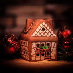 gingerbread house and Christmas decorations on festive backgrou
