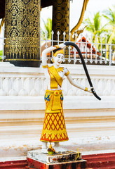 Wall Mural - Statue of a buddhist godt, Luang Prabang, Laos. Vertical. Close-up.