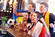 © Kalim - Group of friends watching soccer in pub
