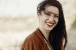 © sonyachny - happy stylish hipster traveler woman having fun waving hair and smiling, gypsy boho girl. wanderlust summer travel. atmospheric moment. space for text.