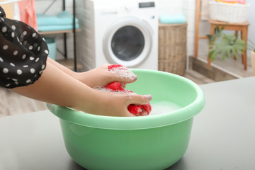 Canvas Print - Woman washing color clothes in basin, closeup