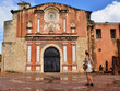 Tourist standing in front of the facade of the Convento de la Orden de los Predicadores in Santo Domingo