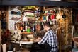 © JackF - male worker sewing stitches on belt in leather workshop