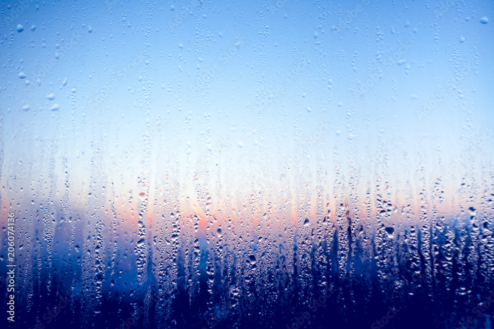 Color Window Liquid Clear water drops on the surface of the glass window. Color transition ...