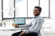 © Syda Productions - business and people concept - african american businessman with pen sitting at office table