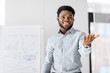 © Syda Productions - business, education and people concept - african american businessman with flip chart at office presentation