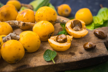 Fresh ripe mushmula or loquat fruit. Good for breakfast and desserts. Evergreen subtropical tree orange sweet and juicy fruit widely spread in Georgia, Japan, Korea, Spain and other asian countries.