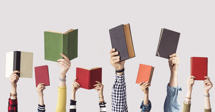 the hands of people hold books