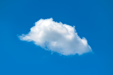 Single white fluffy cloud in the blue sky