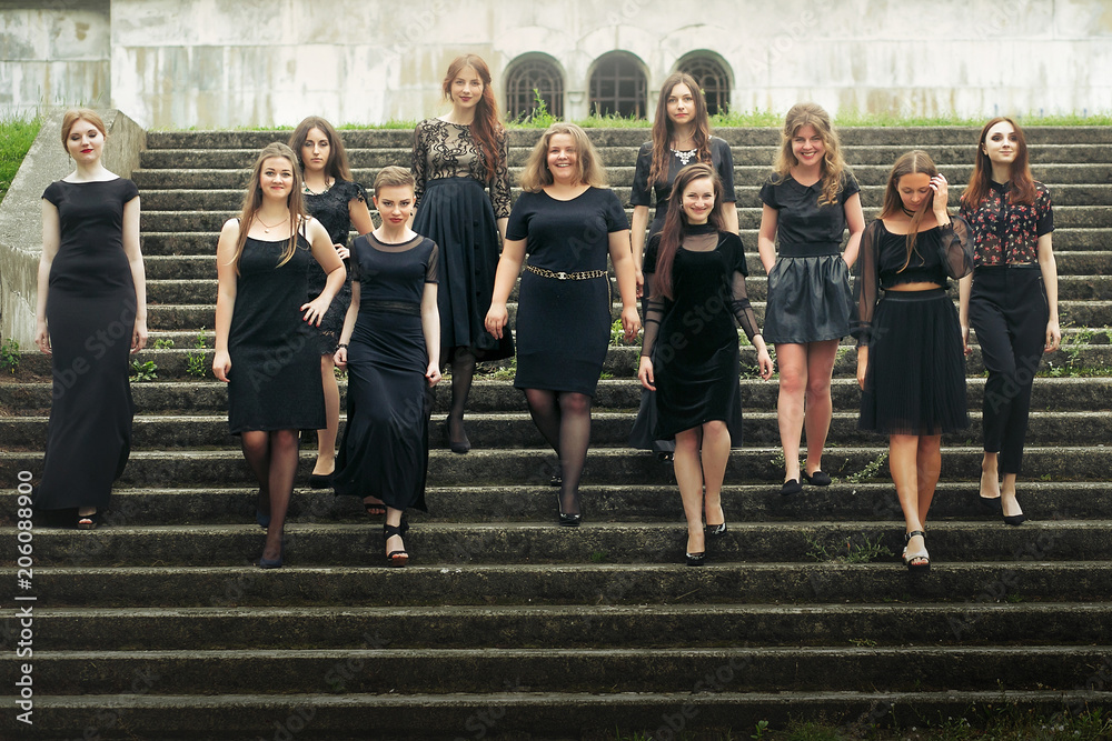 gorgeous women group in black dresses posing walking down the stairs in the  city. stylish lady party with gothic theme. elegant girls Stock Photo |  Adobe Stock
