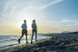 © blicsejo - Man and women running on tropical beach at sunset