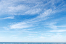 Beautiful Blue Sky Over The Sea With Translucent, White, Cirrus Clouds