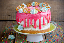 Beautiful Cake Decorated With Pink Chocolate Smudges, Blue Meringue, Sugar Sprinkles And Pretzel Cookies
