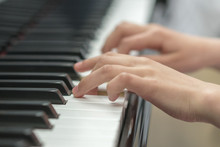 Children's Hands Are Playing The Piano. Child's Hand On Piano Keys.