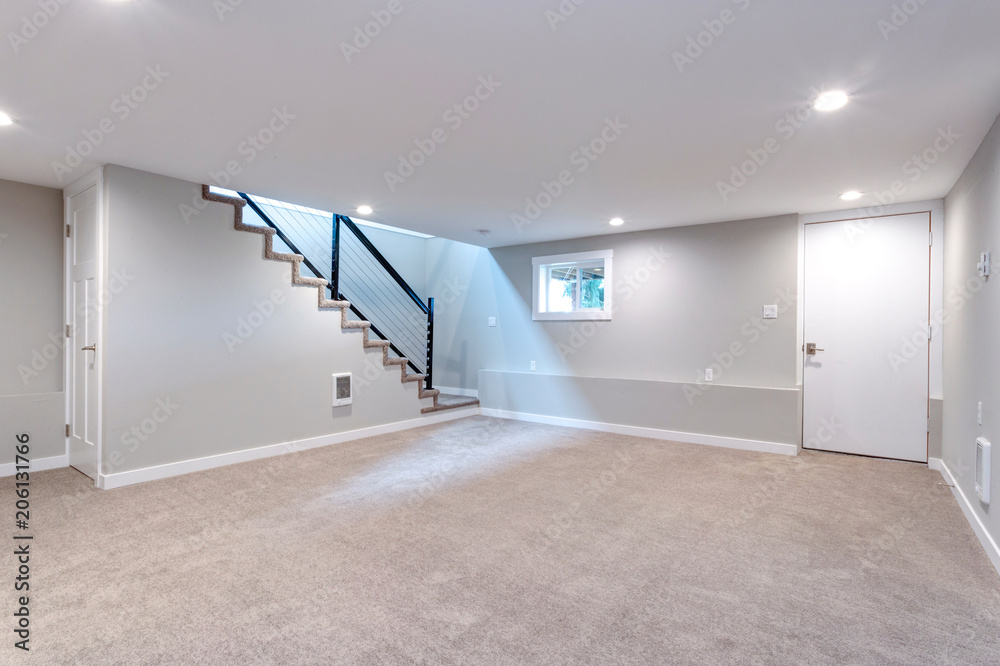 Light spacious basement area with staircase. - obrazy, fototapety, plakaty 