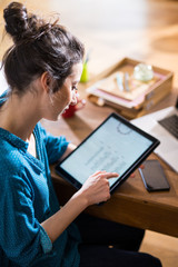 View from above. A woman using a digital tablet 