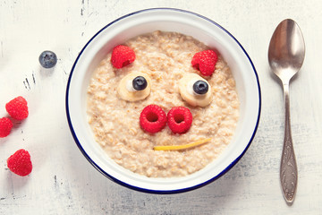 Oatmeal porridge with fruits for kids breakfast