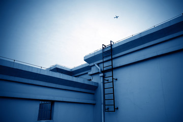 Wall Mural - Passenger aircraft flies over the roof