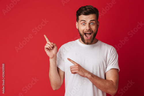 Photographie Handsome young emotional man pointing. Looking camera.
