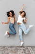 © Drobot Dean - Full length portrait of two cheerful young women