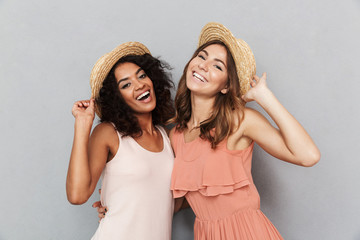 Wall Mural - Portrait of two smiling young women dressed in summer clothes
