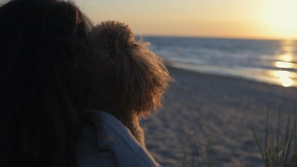 Wall Mural - Woman with her dog at sandy sea beach . Conceptual freedom, travel and holidays image . Slow motion.