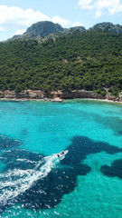 Aerial drone bird's eye view photo of sail boat docked in emerald crystal clear waters, Mykonos island, Cyclades, Greece