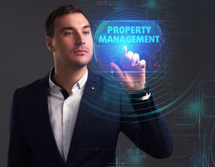 Business, Technology, Internet and network concept. Young businessman working on a virtual screen of the future and sees the inscription: Property management