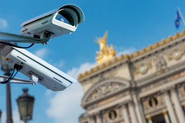 security CCTV camera or surveillance system with ancient monument on blurry background