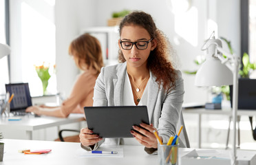 Wall Mural - business, technology and people concept - african american businesswoman with tablet pc computer working at office