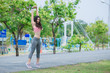 © reewungjunerr - Asian sporty woman stretching body breathing fresh air in the park,Thailand people,Fitness and  exercise concept