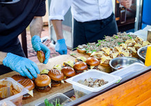 Street Fast Food. Cooks Prepare Different Burgers In Outdoors