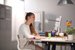 © shefkate - Young woman working in office, sitting at desk. Young woman.
