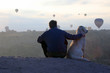 © photosaint - man with a dog looking at the flight of passenger balloons in Cappadocia. Turkey