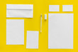 © 9dreamstudio - Blank stationery for branding, envelopes on yellow background top view mockup pattern