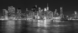 Fototapeta Miasta - New York City skyline reflected in the East River at night, USA.