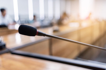 microphone over the blurred business forum or conference training learning room concept, blurred bac
