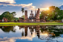 Buddha Statue And Wat Mahathat Temple In The Precinct Of Sukhothai Historical Park, Wat Mahathat Temple Is UNESCO World Heritage Site, Thailand.