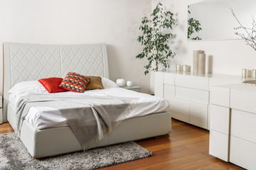 Wall Mural - interior of modern light bedroom with colored pillows on bed