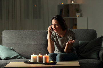 Wall Mural - Woman calling insurance in the night after blackout