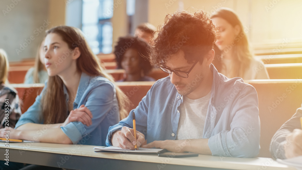Hispanic Young Man Among His Fellow Students in the Classroom. Young ...