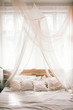 © nataliakabliuk - Hotel room, Wedding bed topped with pillows with canopy net. Mattress wedding.