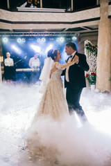 First wedding dance of newlywed. Amazing dancing bride and groom on low light and heavy smoke.  A lot of confetti.