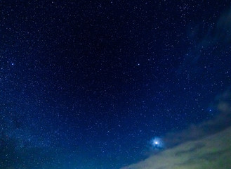 starry sky and illuminated clouds.