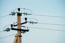 Power Lines On Background Of Blue Sky Close-up. Electric Hub On Pole. Electricity Equipment With Copy Space. Wires Of High Voltage In Sky. Electricity Industry.