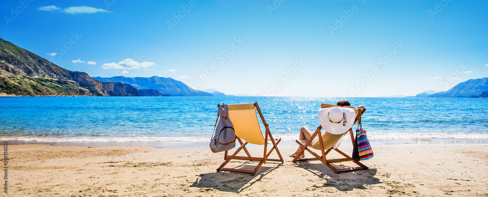 Woman enjoying sunbathing at beach - obrazy, fototapety, plakaty 