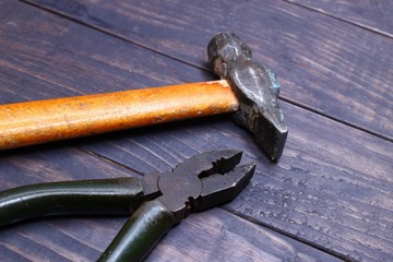 Wall Mural - Hammer, pliers tools on a dark background