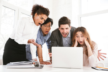 Wall Mural - Group of an astonished young multiethnic businesspeople